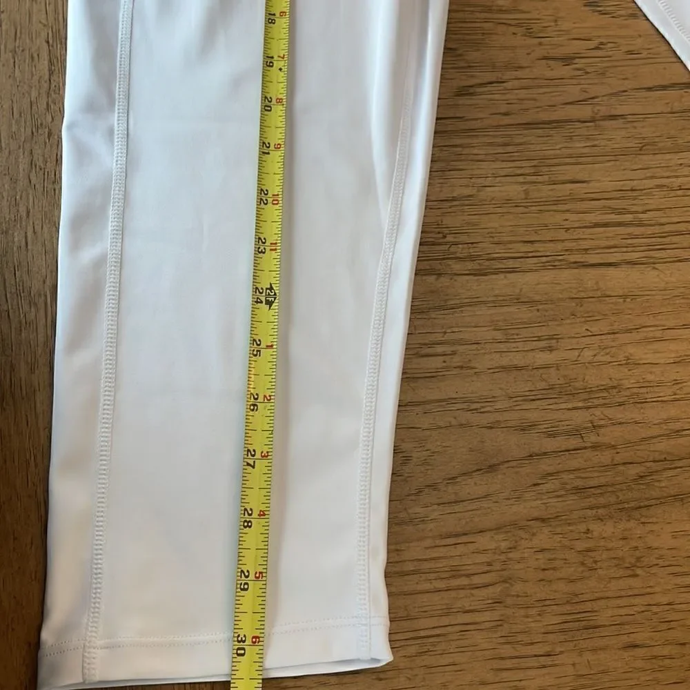 Kcutteyg white exercise capris with side pockets.  New with tags